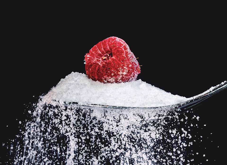 spoon of sugar with raspberry on top